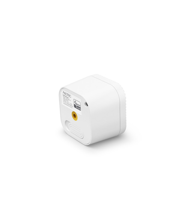 Mazs, balts sensors ar vairākām lēcām un LED indikatoru, novietots uz pelēka fona.